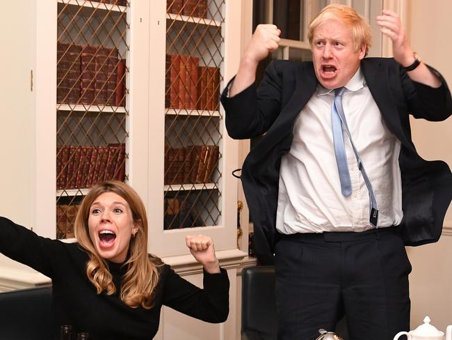 Britain's Prime Minister Boris Johnson and his partner Carrie Symonds watch the 2019 election results on the TV. Picture: Andrew Parsons