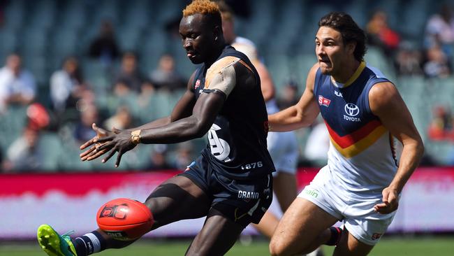 Hot prospect ... South Adelaide’s Emmanuel Irra gets his kick in ahead of Crow Troy Menzel during the SANFL first semi-final. Picture: Tom Huntley