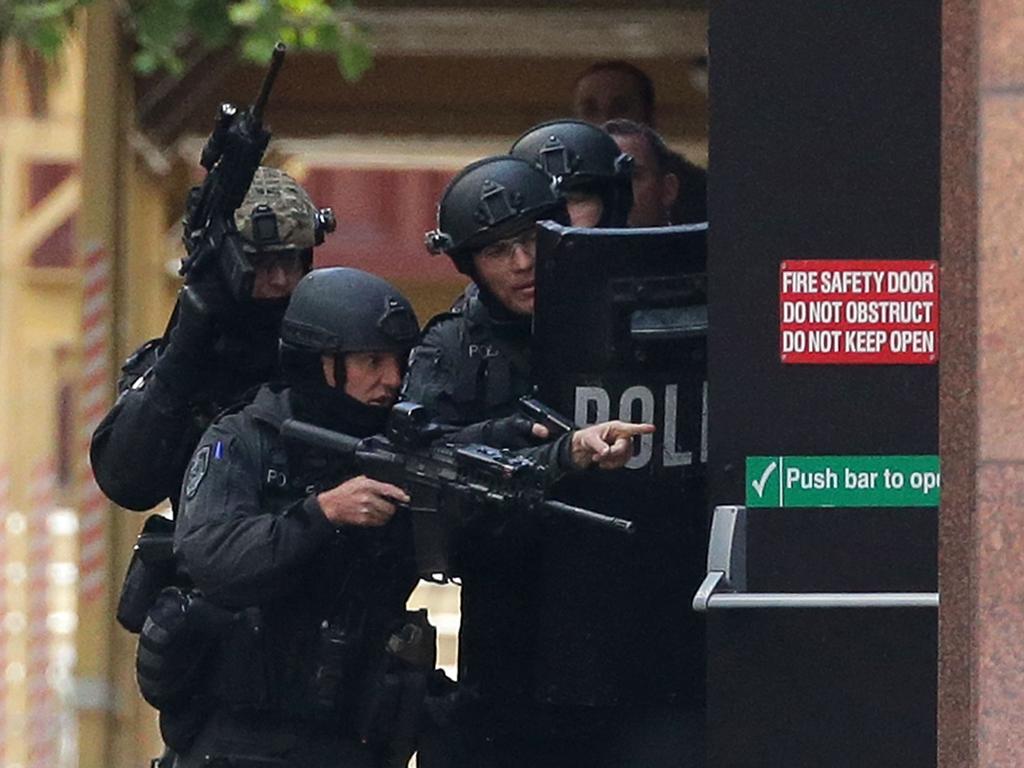 11. As afternoon turns to evening, officers from the tactical operations unit officers cement their positions ahead of a possible assault.