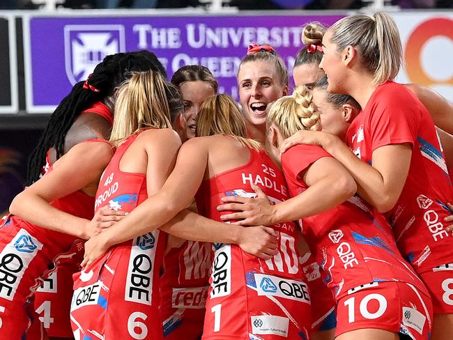 BRISBANE, AUSTRALIA - MAY 02: The Swifts players embrace during the round one Super Netball match between Queensland Firebirds and Sydney Swifts at Nissan Arena, on May 02, 2021, in Brisbane, Australia. (Photo by Bradley Kanaris/Getty Images)