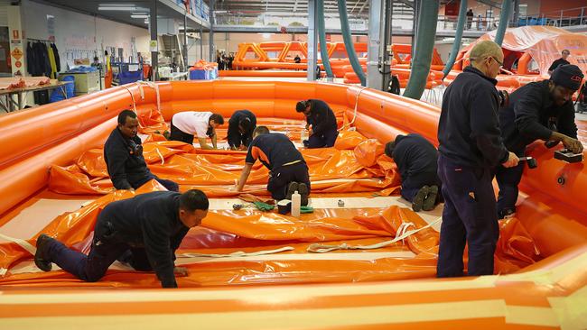 Workers at the Liferaft Systems Australia factory at Derwent Park. Picture: SAM ROSEWARNE