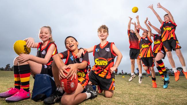 Kaitlyn Bentley, 9, Jack Owen, 8 and Noah Beacham, 7, and friends. The under-10 Wyndham Suns have the cheapest football rego costs in Melbourne ($100). Picture: Jason Edwards