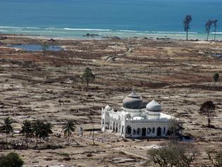 (FILES) This aerial file photo taken on January 16, 2005 shows a partly damaged mosque in the Lampuuk coastal district of Banda Aceh on Indonesia's Sumatra island, an area which was devastated in the earthquake and tsunami on December 26, 2004. Indonesia will mark on December 26, 2014 the 10th year anniversary of the deadly tsunami which killed more than 170,000 people in Aceh, and tens of thousands of others in other countries around the Indian Ocean. AFP PHOTO / FILES / JOEL SAGET