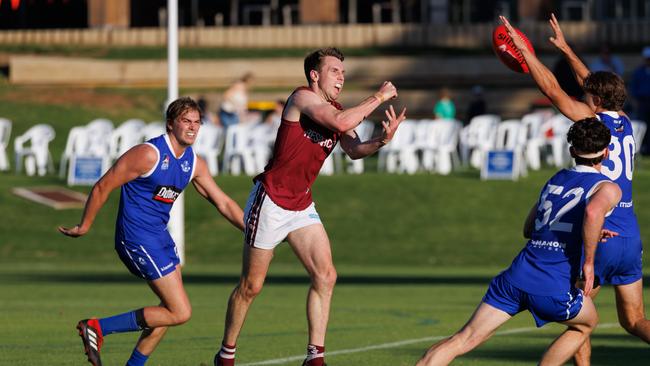 Prince Alfred OC captain Craig Pitt handballs clear against SPOC. Picture: In Flight Sports