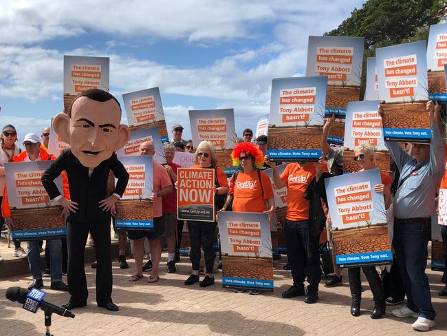 GetUp! volunteers in the federal electorate of Warringah, along with a Tony Abbott figure, gather at Manly Beach at the launch of the lobby group's national campaign to unseat conservative MPs. Picture: Jim O'Rourke 