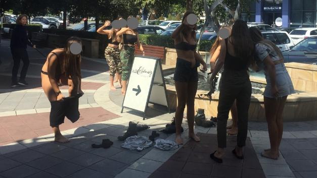 A group of girls stripped semi-naked and danced in the fountain at Fountain Plaza.