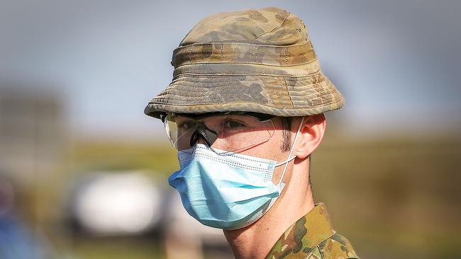 An ADF member inspects cars at a vehicle checkpoint on the Princes Highway at Little River, near Geelong , Victoria. Picture: Ian Currie/NCA NewsWire