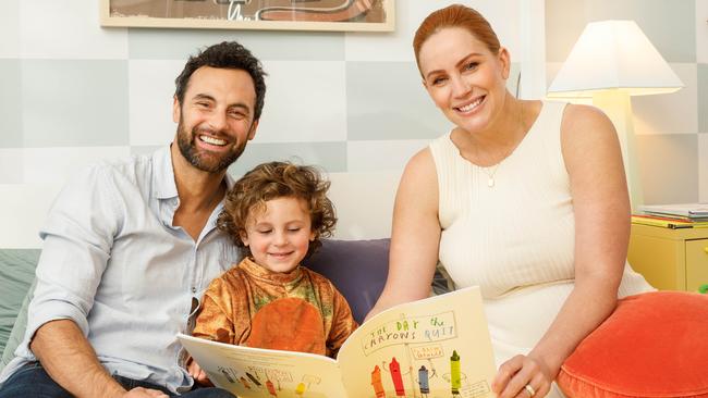 Cam Merchant, left, son Oliver, three, and Jules Robinson read multiple books together in Ollie’s room each night, now joined by newborn baby Carter. Picture: Max Mason-Hubers