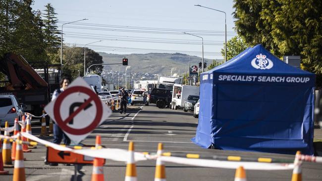 Police at the scene of the unexplained death on Matipo St, Riccarton. Pools of blood were seen in the gutter where emergency services equipment lay. Picture: George Heard