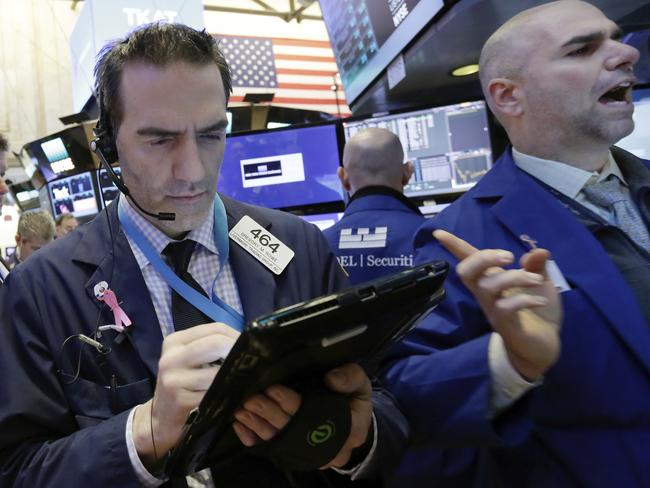 Trader Gregory Rowe, center, and specialist Philip Finale, right, work on the floor of the New York Stock Exchange, Wednesday, March 22, 2017. Stocks are treading water in early trading as gains in high-dividend stocks are outweighed by drops in banks and other sectors. (AP Photo/Richard Drew)