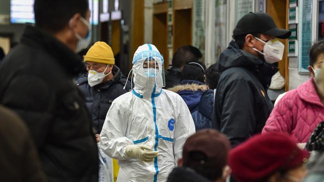 A medical staff member wearing protective clothing walks at the Wuhan Red Cross Hospital in Wuhan on January 24, as Chinese authorities finally rapidly expanded a mammoth quarantine effort. Picture: Hector Retamal/AFP