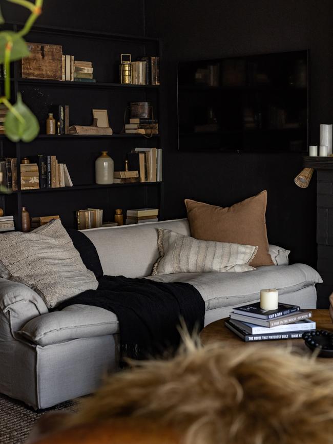 The Binney’s cosy lounge features a super comfy, linen-covered couch, warm black paint scheme and soft, modern light fittings and a custom-designed library wall stocked with vintage books. Dearna Bond