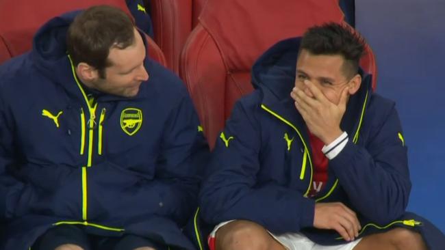 Alexis Sanchez tries to hide laughter.