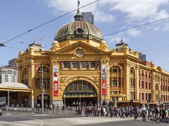 Melbourne, Australia: October 07, 2015: People cross the street in front of Flinders Street Station. It is the main railway station in Melbourne. Picture: istock