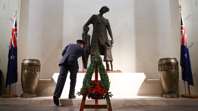 A poppy is placed at the base of Lyndon Smith's statue “Mother and Children” in the Hall of Memories during the Anzac Day Dawn Service at Pukeahu National War Memorial Park on  in Wellington.