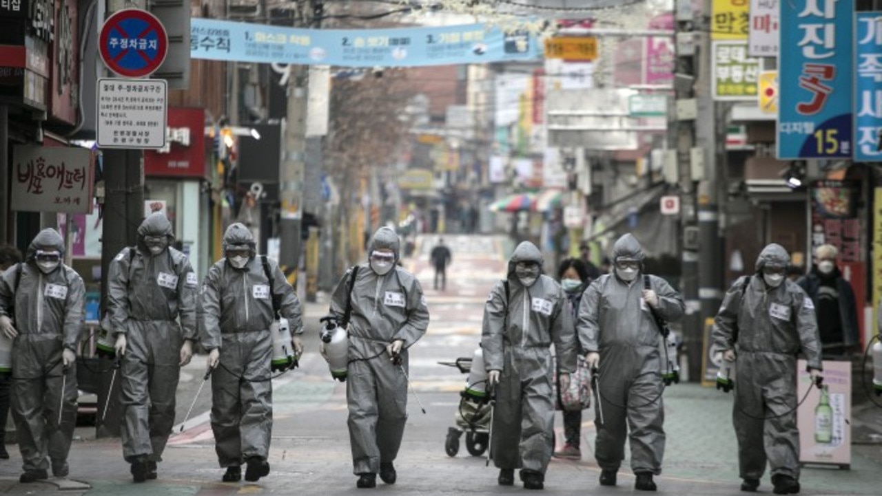 South Korean soldiers, in protective gear, disinfect the Eunpyeong district against the coronavirus in Seoul, South Korea. Picture: Woohae Cho/Getty Images