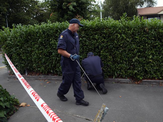 Police look for evidence in the surrounding streets near the mosque. Picture Gary Ramage