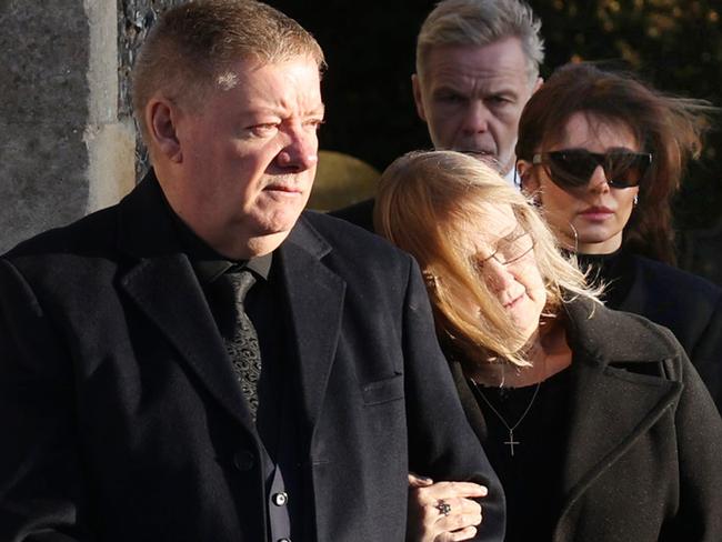 Karen and Geoff Payne, followed by Cheryl Tweedy, watch the procession. Picture: Dan Kitwood/Getty Images)