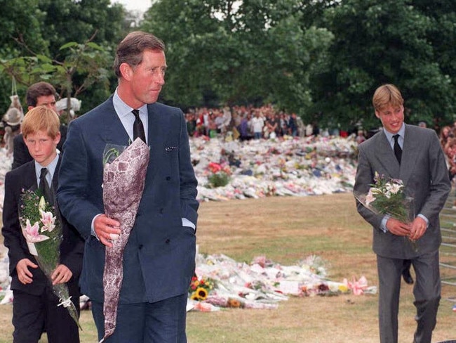 Charles, The Prince of Wales, and his sons, Prince Harry and Prince William, collecting floral tributes to their mother, Diana, Princess of Wales, from the crowd at Kensington Palace in September, 1997. Picture: Rebecca Naden