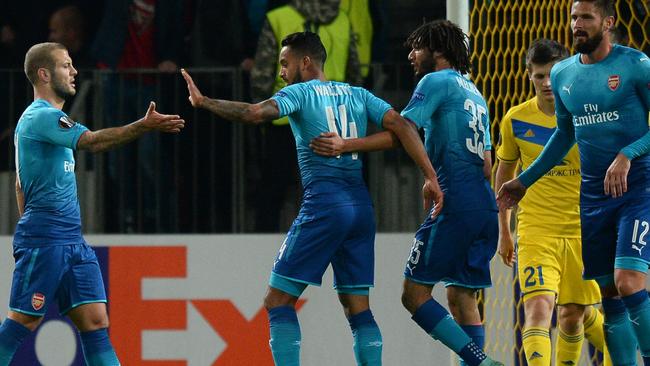 Arsenal's forward from England Theo Walcott (C) celebrates with teammates