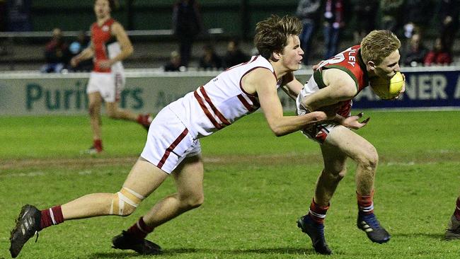 Henley High School's Cooper Horsnell is tackled by Prince Alfred College's Jesse Bruce at the State knockout football final, at Norwood Oval Picture: Bianca De Marchi