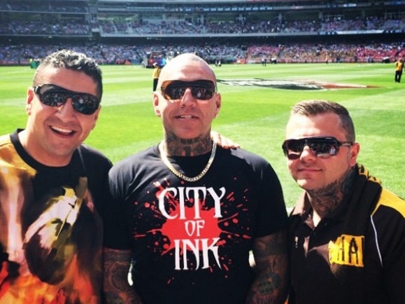 Suspected links have emerged between a $12 million tobacco bust and Kazem Hamad’s outlaw smoke empire. Kazem Hamad is pictured left at the footy with Toby Mitchell and senior Mongol bikie Tyrone Bell. Picture: Instagram