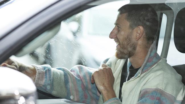 Essendon player Dyson Heppell drives away after undergoing a coronavirus test in Melbourne on Monday. Picture: AAP