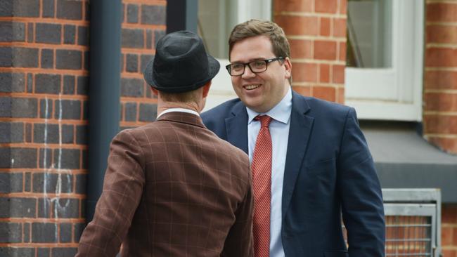 Education Minister John Gardner (right) is greeted by a staff member as he arrives at Black Forest Primary School’s 100th anniversary celebrations. Picture: AAP Image/Brenton Edwards