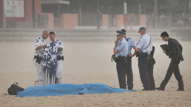 Police at the scene after a body, believed to be Tui Gallaher, was pulled from the surf. Picture: Dylan Decosta