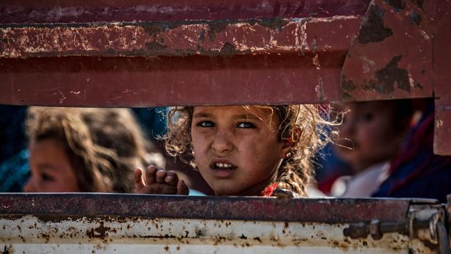 Young Kurds arrive in the Syrian town of Tal Tamr town after fleeing the Turkish bombardment. Picture: AFP