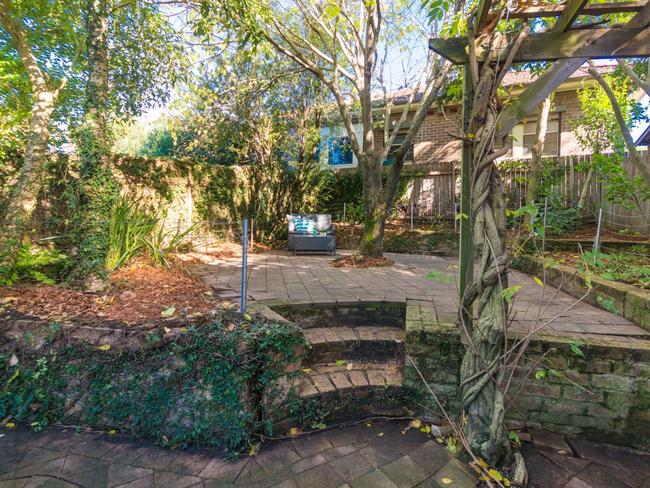 There is a paved courtyard at the rear.
