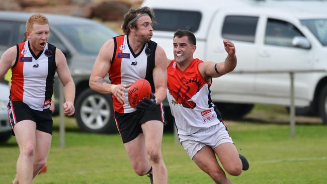 Benjamin Ross attempts to tackle Christies Beach’s Jarryd McCormack in their last Southern clash last month. Picture: AAP/Brenton Edwards