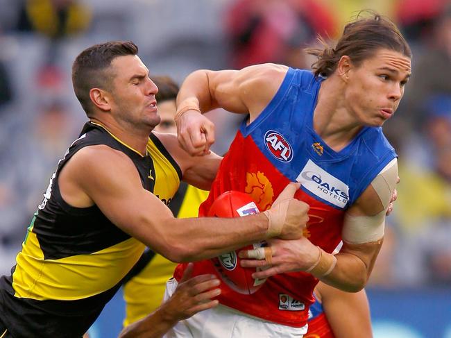 MELBOURNE, AUSTRALIA - APRIL 14:  Jack Graham of the TIgers tackles Eric Hipwood of the Lions during the round four AFL match between the Richmond Tigers and the Brisbane Lions at Melbourne Cricket Ground on April 14, 2018 in Melbourne, Australia.  (Photo by Darrian Traynor/Getty Images)