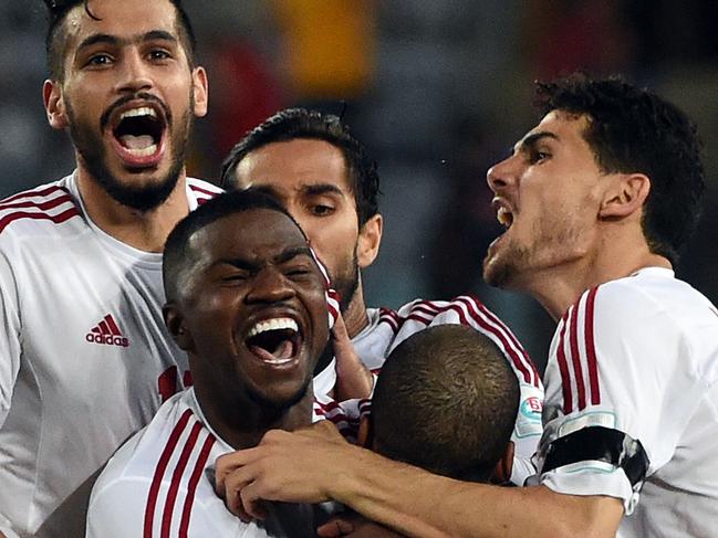 United Arab Emirates players celebrate their victory against Japan during the quarter-final football match between Japan and UAE at the AFC Asian Cup in Sydney on January 23, 2015. AFP PHOTO / Saeed KHAN --IMAGE RESTRICTED TO EDITORIAL USE - STRICTLY NO COMMERCIAL USE