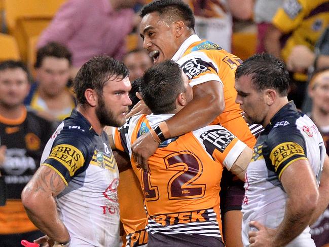 BRISBANE, AUSTRALIA - MARCH 20: Jordan Kahu of the Broncos is congratulated by team mates after scoring a try during the round three NRL match between the Brisbane Broncos and the North Queensland Cowboys at Suncorp Stadium on March 20, 2015 in Brisbane, Australia. (Photo by Bradley Kanaris/Getty Images)