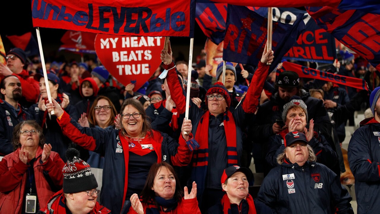 Melbourne Demons fans celebrate in lockdown