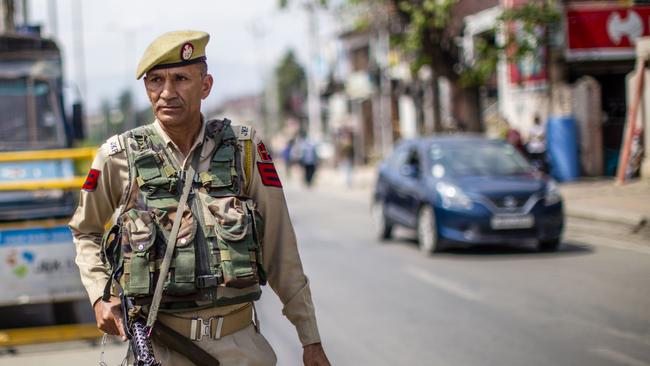 An Indian policeman stands guard on a road, in Kashmir. Picture: Yawar Nazir/Getty Images