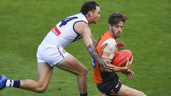 GWS co-captain Callan Ward collects in front of former teammate Nathan Wilson. Ward won a heap of the ball. Pic: AAP