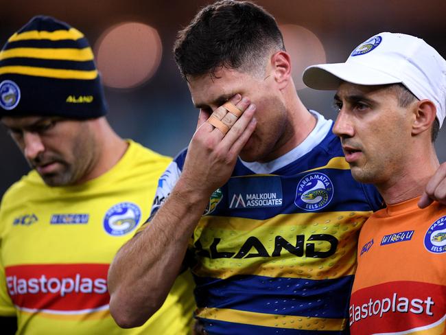 Mitchell Moses of the Eels reacts while being assisted from the field after sustaining a knee injury during the Round 13 NRL match between the Parramatta Eels and the Newcastle Knights at ANZ Stadium in Sydney, Saturday, June 2, 2018. (AAP Image/Dan Himbrechts) NO ARCHIVING, EDITORIAL USE ONLY