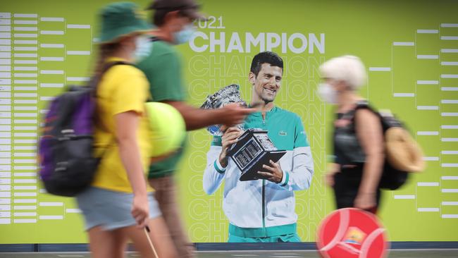 Fans pass by the draw outside Rod Laver Arena. Picture: David Caird