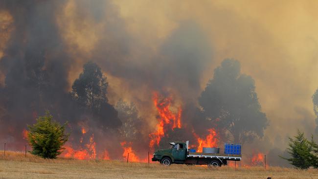 A truck loaded with water on the scene of the 2013 Dunalley bushfires. Picture: Richard Jupe