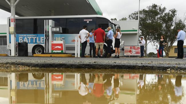 Members of the media travelling on the One Nation 'Battler Bus' look on after the bus broke down in Marlborough, north of Rockhampton. Picture: AAP Image/Dave Hunt.