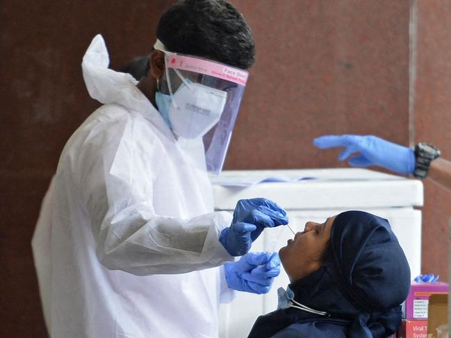 Passengers arriving on international flights get their Covid-19 coronavirus screening done at the Anna International airport in Chennai on April 28, 2021. (Photo by Arun SANKAR / AFP)