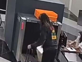 The woman, thought to be Brittney Griner, is seen at airport security. Picture: Video footage/supplied