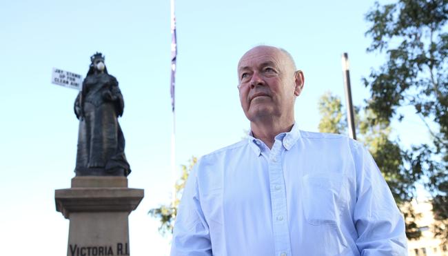 Port Augusta business owner Alan McMahon in front a prominent Adelaide statue donning a dust mask demanding Premier Jay Weatherill commit to cleaning up the town’s dust issue. Pic: Greenpeace