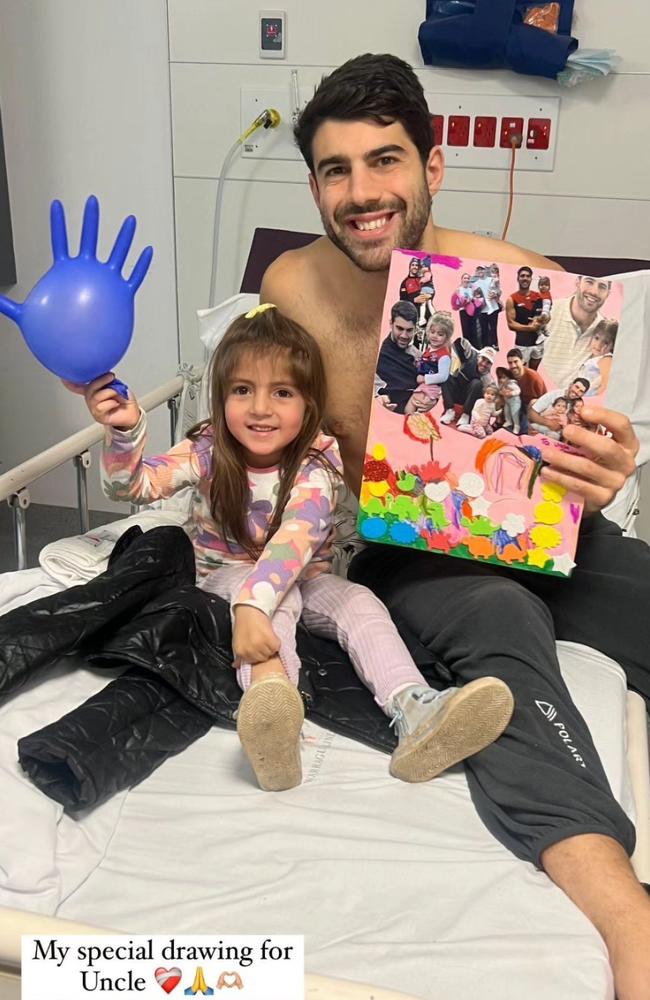 Melbourne AFL player Christian Petracca in hospital with his Niece. He suffered horrific injuries, including four broken ribs, a lacerated spleen, and a small punctured lung after a knee from Darcy Moore of the Pies. Picture: Instagram