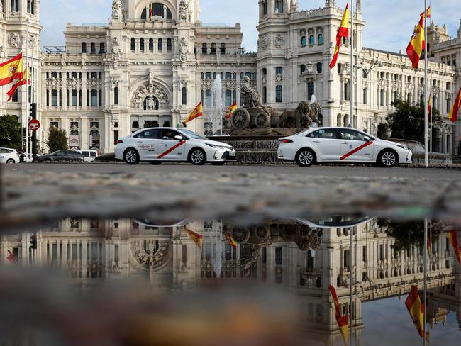 The Spanish flag flying at half-mast at the start of three days of national mourning after Spain's deadliest floods in decades, at Cibeles Square in Madrid. Picture: AFP