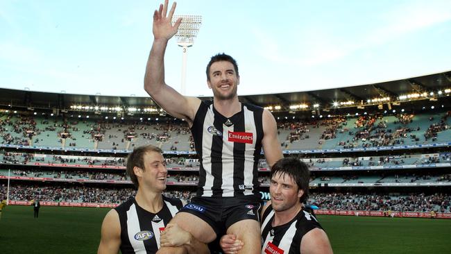 Darren Jolly, getting chaired off, won two premierships with two clubs during his career. Picture: Michael Klein