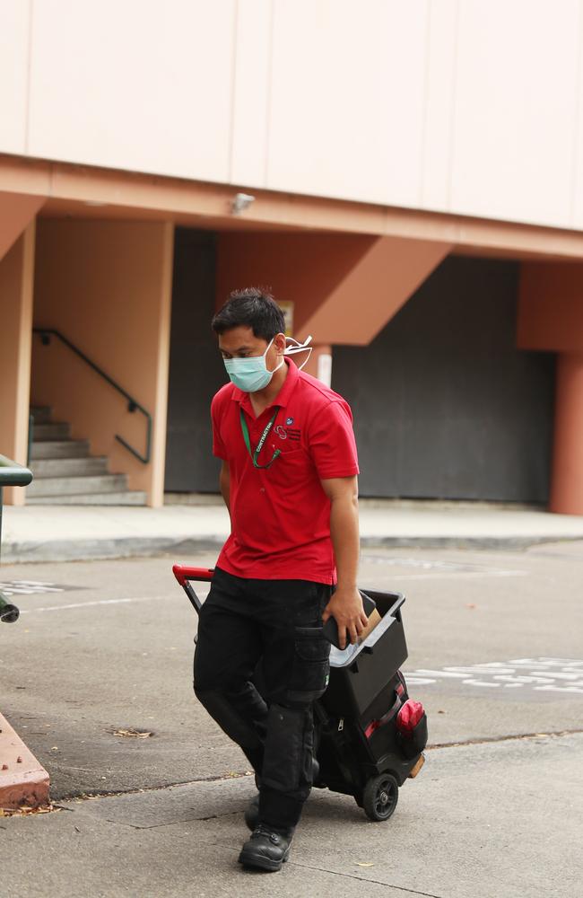 A workers near the Ibis and Novotel hotels where a cleaner was the first of four quarantine infections of COVID-19 in a month. Picture: John Grainger.