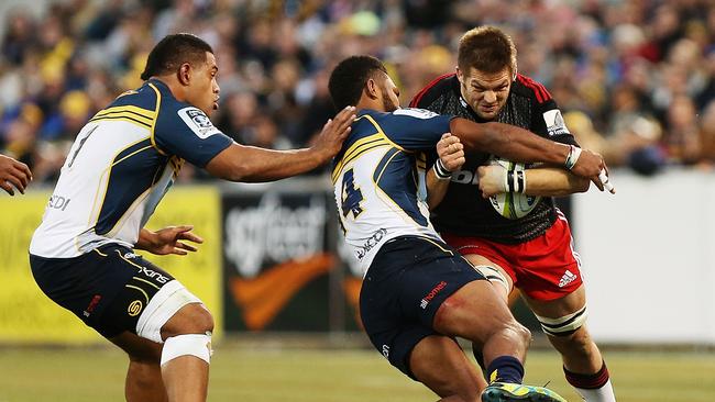 Richie McCaw of the Crusaders is tackled.